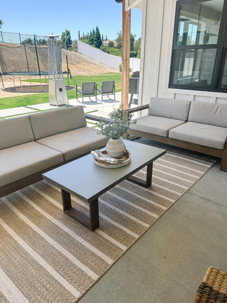 Outdoor patio furniture with comfortable sofas and a coffee table.