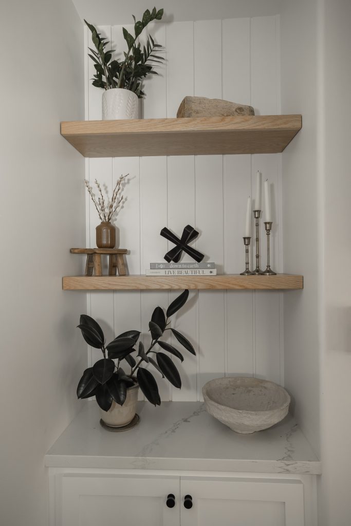 Elegant fireplace nook with wooden shelves and decorative accents.