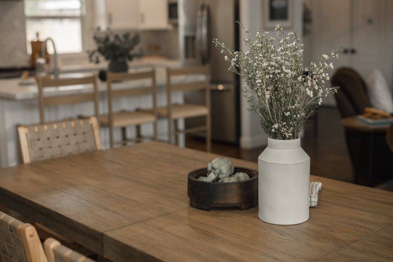 Stylish kitchen dining space with wooden table and minimalist decor.