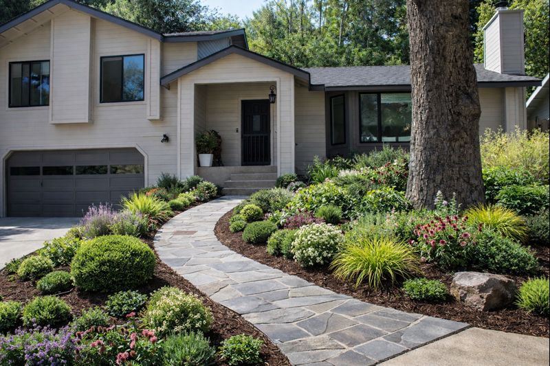Front exterior of a modern home with updated siding, landscaping, and welcoming entryway.